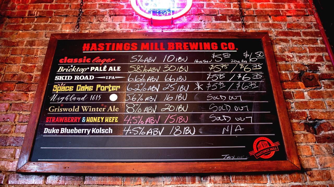 Chalkboard sign listing all the Hastings Mill Brewing Co beers